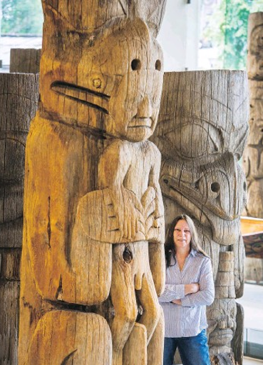 Dr.Steeves standing next to a Totem